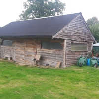 Chestnut clad round pole timber barn