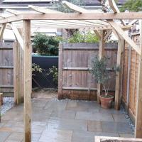  Radial pergola and Indian stone patio with planter and artificial lawn